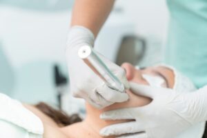 services-01 Close-up of a cosmetic treatment being performed in a clinical environment.